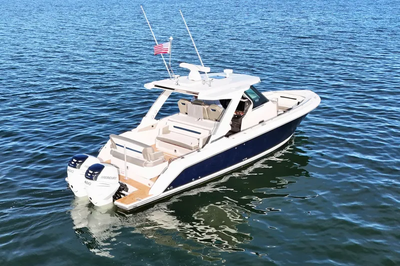 Slide: The Image of 2022 Tiara Yachts 34 LS on calm blue water, featuring dual Mercury engines. - 3