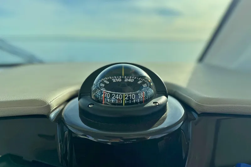 Slide: The Image of Compass on 2022 Tiara Yachts 34 LS dashboard, with ocean view in background. - 32