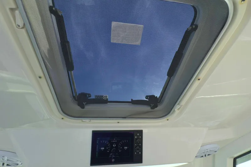 Slide: The Image of 2022 Tiara Yachts 34 LS interior with skylight and control panel. - 33