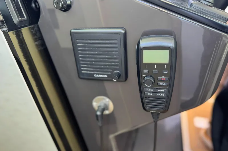 Slide: The Image of Garmin marine radio and speaker on 2022 Tiara Yachts 34 LS dashboard. - 35