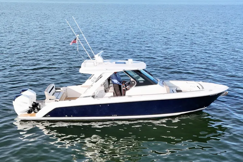 Slide: The Image of 2022 Tiara Yachts 34 LS boat on calm water, side view. - 4