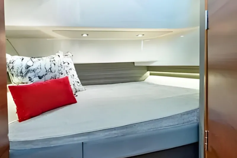 Slide: The Image of Interior cabin of 2022 Tiara Yachts 34 LS with cozy bedding and modern lighting. - 42