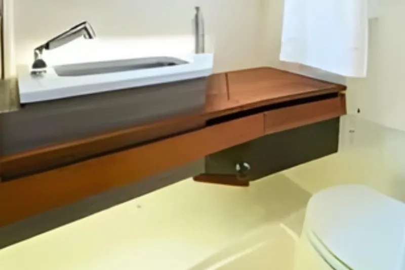 Slide: The Image of 2022 Tiara Yachts 34 LS bathroom with modern sink and wooden cabinetry. - 43