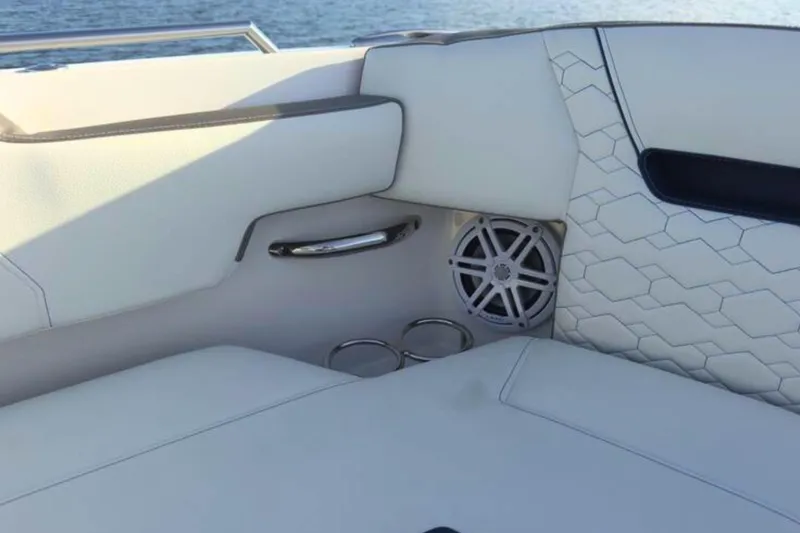 Slide: The Image of Luxury seating on 2022 Tiara Yachts 34 LS, featuring speaker and cup holders. - 46