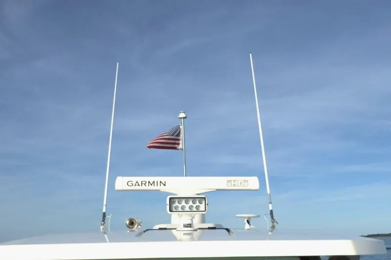 Slide: The Image of Tiara Yachts 34 LS 2022 with Garmin radar and American flag against blue sky. - 51