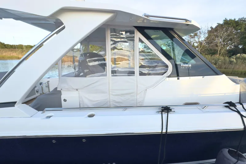 Slide: The Image of 2022 Tiara Yachts 34 LS docked, featuring sleek design and enclosed cabin. - 53