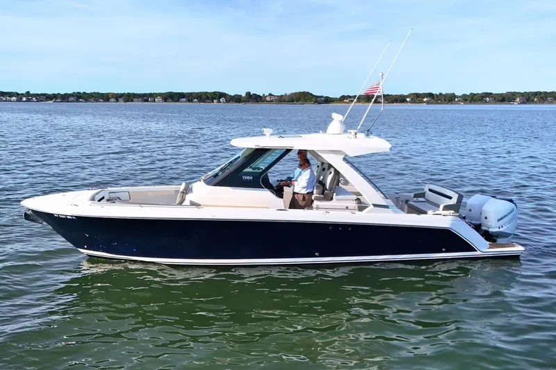 Slide: The Image of 2022 Tiara Yachts 34 LS cruising on a calm lake with clear skies. - 6