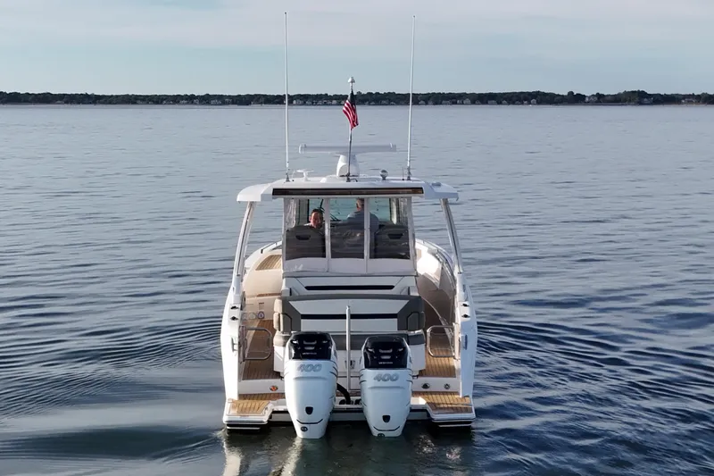 Slide: The Image of 2022 Tiara Yachts 34 LS on calm water, rear view with dual engines. - 9