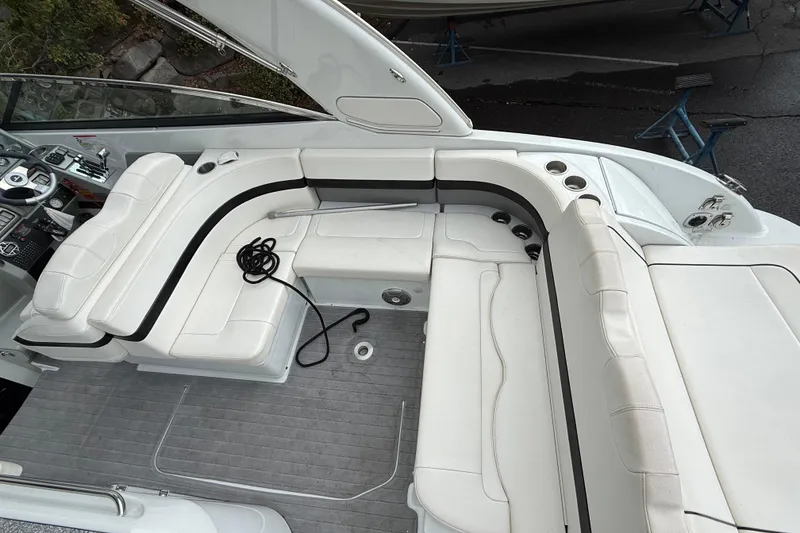 Slide: The Image of 2010 Formula 290 Sun Sport boat with white seating and black accents. - 3
