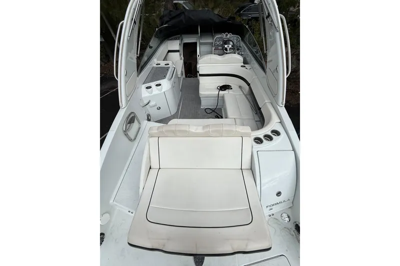 Slide: The Image of 2010 Formula 290 Sun Sport boat interior with white seating and control panel. - 4