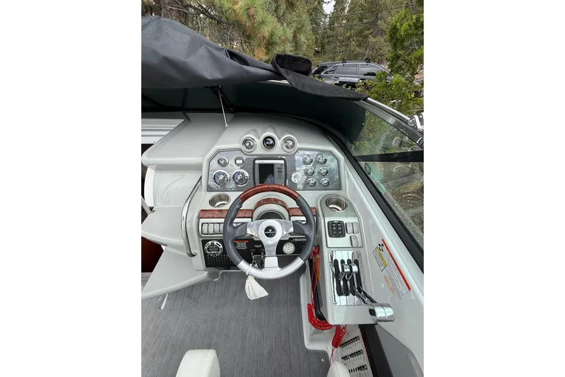 Slide: The Image of Cockpit of 2010 Formula 290 Sun Sport boat with steering wheel and control panel. - 7