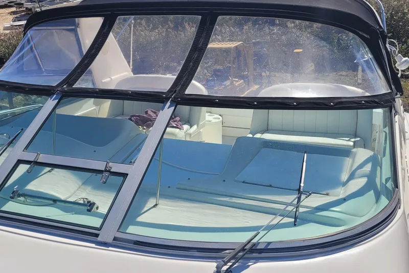 Slide: The Image of 1997 Sea Ray 330 Express Cruiser with spacious cockpit and windshield, docked outdoors. - 12