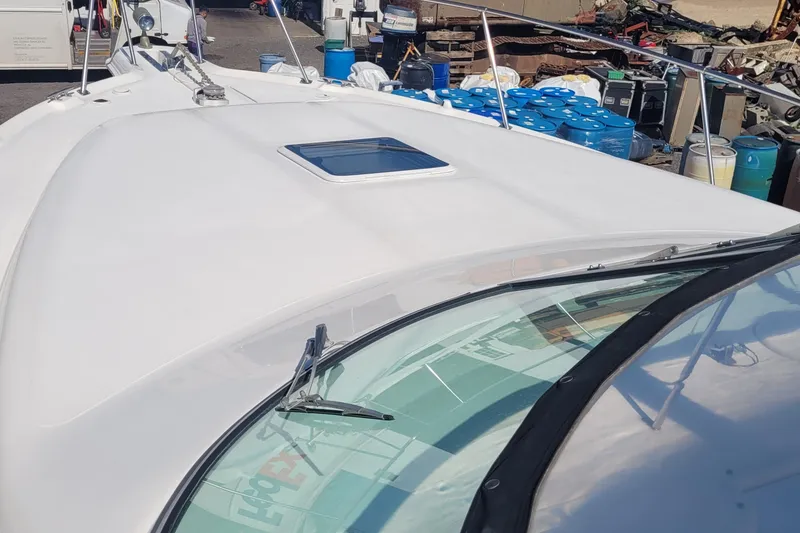 Slide: The Image of 1997 Sea Ray 330 Express Cruiser boat deck with windshield and hatch. - 14