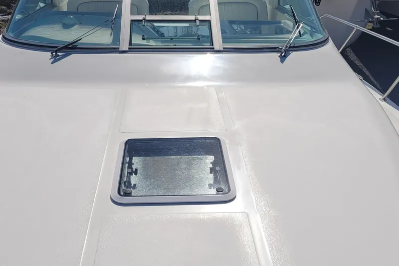 Slide: The Image of 1997 Sea Ray 330 Express Cruiser deck with windshield and hatch. - 15