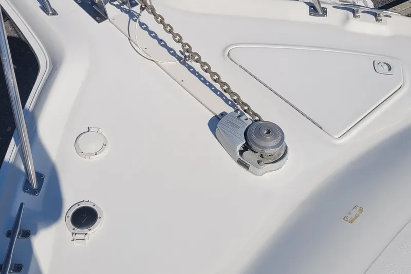 Slide: The Image of 1997 Sea Ray 330 Express Cruiser deck with anchor chain and winch. - 16