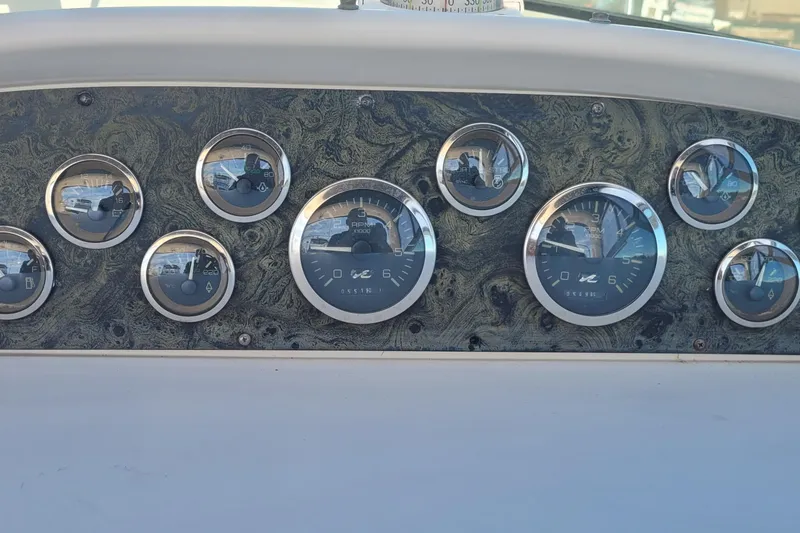 Slide: The Image of 1997 Sea Ray 330 Express Cruiser dashboard with multiple gauges and dials. - 20