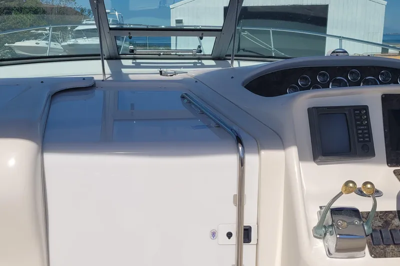 Slide: The Image of 1997 Sea Ray 330 Express Cruiser dashboard with navigation controls and gauges. - 24