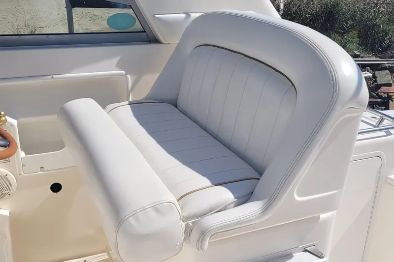 Slide: The Image of 1997 Sea Ray 330 Express Cruiser white leather seating in sunlight. - 31