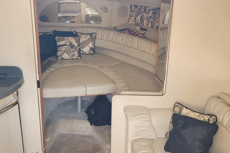 Slide: The Image of Interior of 1997 Sea Ray 330 Express Cruiser with cozy seating and cushions. - 35