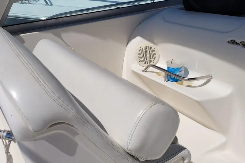 Slide: The Image of Interior of 1997 Sea Ray 330 Express Cruiser with white seating and cup holder. - 42