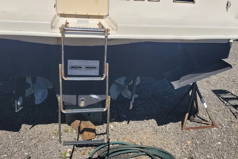 Slide: The Image of 1997 Sea Ray 330 Express Cruiser stern with ladder and propellers on display. - 43