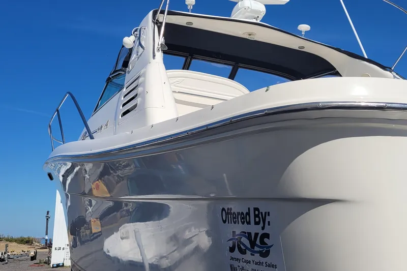 Slide: The Image of 1997 Sea Ray 330 Express Cruiser yacht with sleek design under clear blue sky. - 5