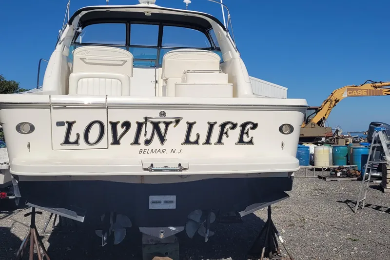 Slide: The Image of 1997 Sea Ray 330 Express Cruiser named "Lovin' Life" in Belmar, NJ, docked on land. - 7