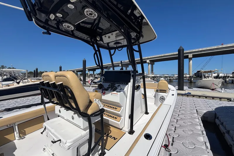 Slide: The Image of 2021 Sportsman Masters 247 Bay Boat docked, featuring sleek design and modern controls. - 12