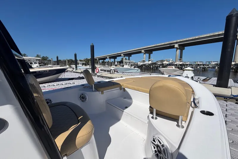 Slide: The Image of 2021 Sportsman Masters 247 Bay Boat docked near a bridge on a sunny day. - 13