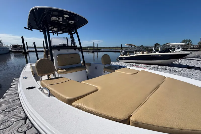 Slide: The Image of 2021 Sportsman Masters 247 Bay Boat docked, featuring tan seating and sleek design. - 14
