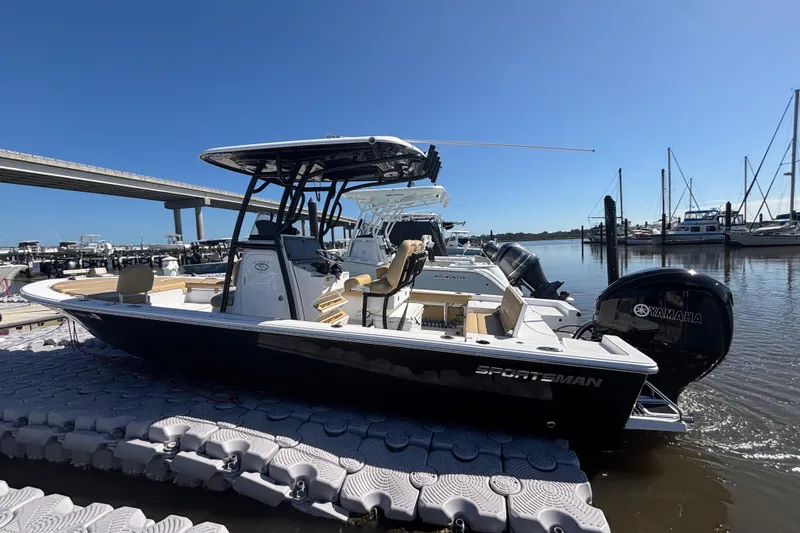 Slide: The Image of 2021 Sportsman Masters 247 Bay Boat docked at marina under clear blue sky. - 4