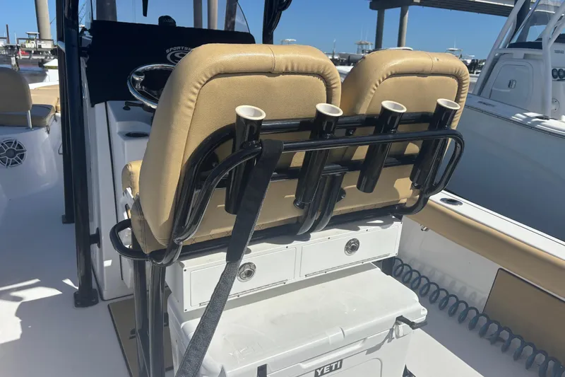 Slide: The Image of 2021 Sportsman Masters 247 Bay Boat interior with tan seats and rod holders. - 5