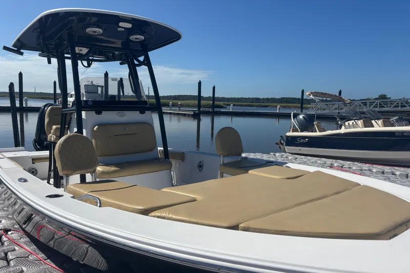 Slide: The Image of 2021 Sportsman Masters 247 Bay Boat docked at marina under clear blue sky. - 6
