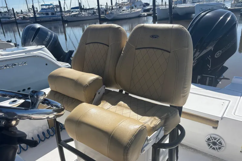 Slide: The Image of 2021 Sportsman Masters 247 Bay Boat with tan leather seats at marina. - 7