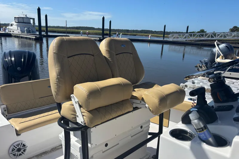 Slide: The Image of 2021 Sportsman Masters 247 Bay Boat with tan seats at a marina dock. - 9