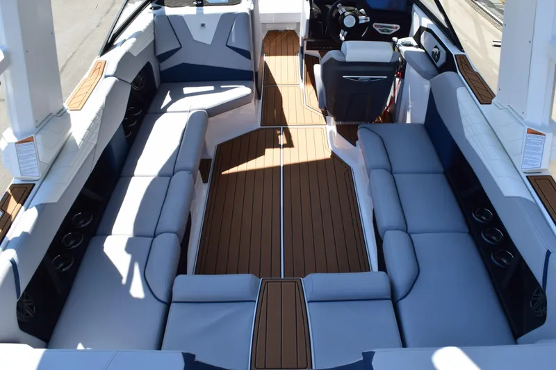 Slide: The Image of 2025 Nautique Super Air Nautique S23 interior with spacious seating and sleek design. - 12