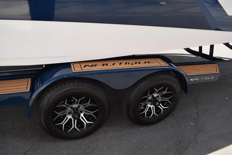Slide: The Image of Trailer of 2025 Nautique Super Air Nautique S23 with stylish wheels. - 16