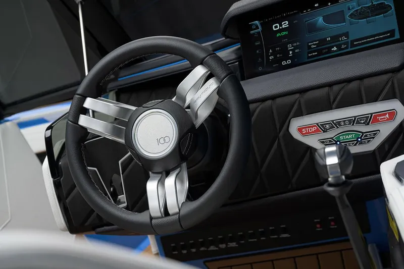 Slide: The Image of Manufacturer Provided Image: 2025 Nautique Super Air Nautique S23 dashboard with steering wheel and digital display. - 24