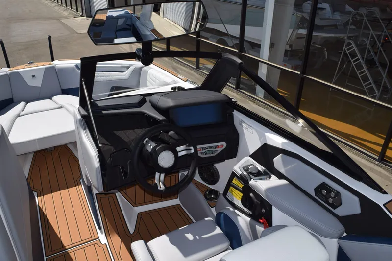 Slide: The Image of Interior of 2025 Nautique Super Air Nautique S23 boat, featuring modern helm and seating. - 8