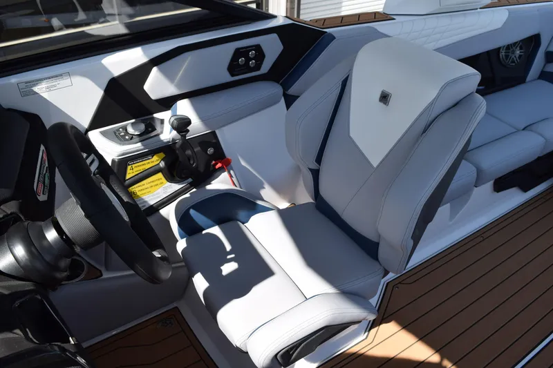 Slide: The Image of 2025 Nautique Super Air Nautique S23 cockpit with modern steering and luxurious seating. - 9