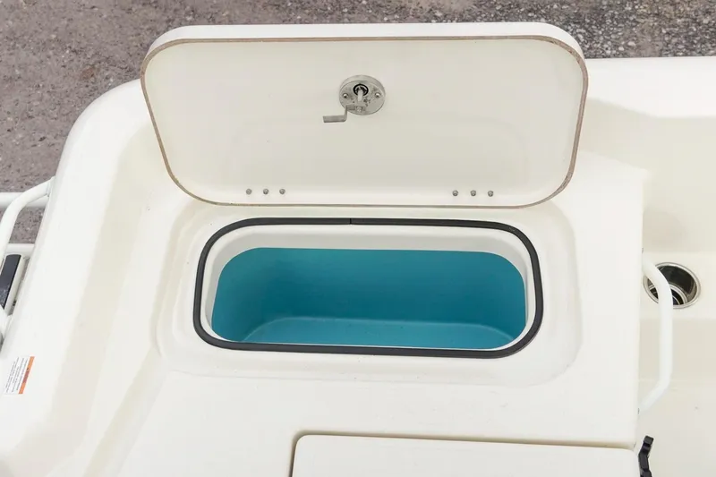 Slide: The Image of Open storage compartment on 2025 Skeeter SX2350 boat, featuring a blue interior. - 13