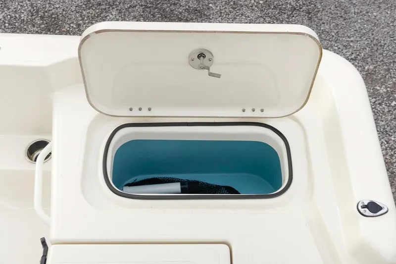 Slide: The Image of Open storage compartment on 2025 Skeeter SX2350 boat, featuring a blue interior. - 14