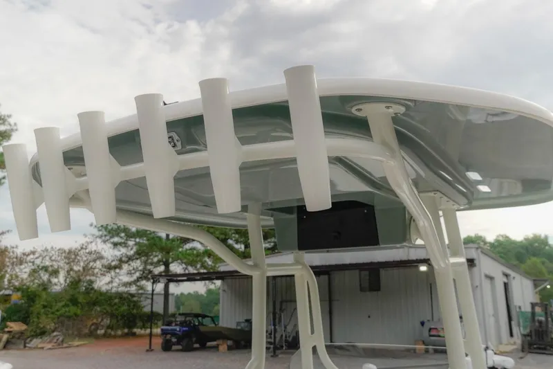 Slide: The Image of 2025 Skeeter SX2350 boat with rod holders and canopy, outdoor setting. - 15