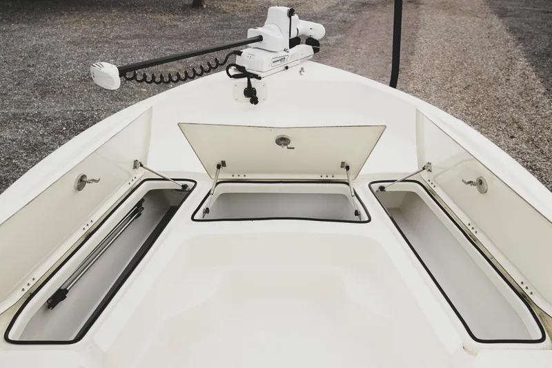 Slide: The Image of 2025 Skeeter SX2350 boat with open storage compartments and trolling motor. - 17