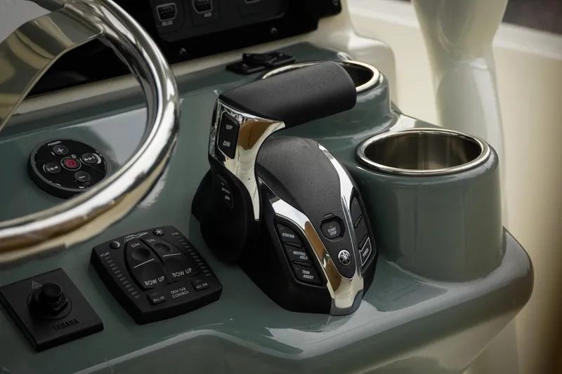 Slide: The Image of 2025 Skeeter SX2350 boat console with controls and cup holders. - 21