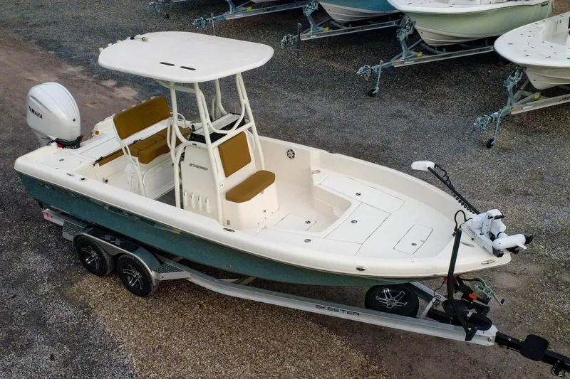 Slide: The Image of 2025 Skeeter SX2350 boat on trailer, featuring Yamaha engine and spacious deck design. - 24