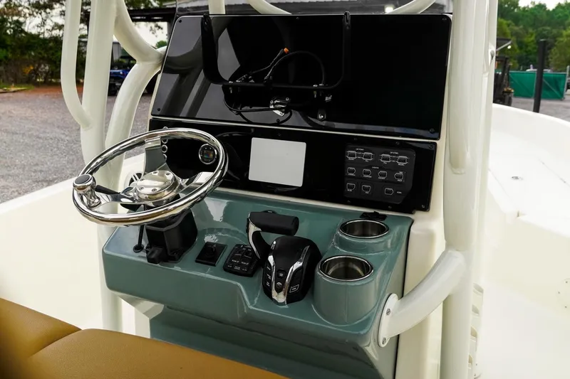 Slide: The Image of 2025 Skeeter SX2350 boat console with steering wheel and control panel. - 8