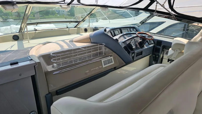 Slide: The Image of 1999 Sea Ray 500 Sundancer helm with leather seating and modern controls. - 14