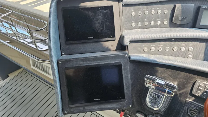 Slide: The Image of Control panel of a 1999 Sea Ray 500 Sundancer yacht with navigation screens. - 17