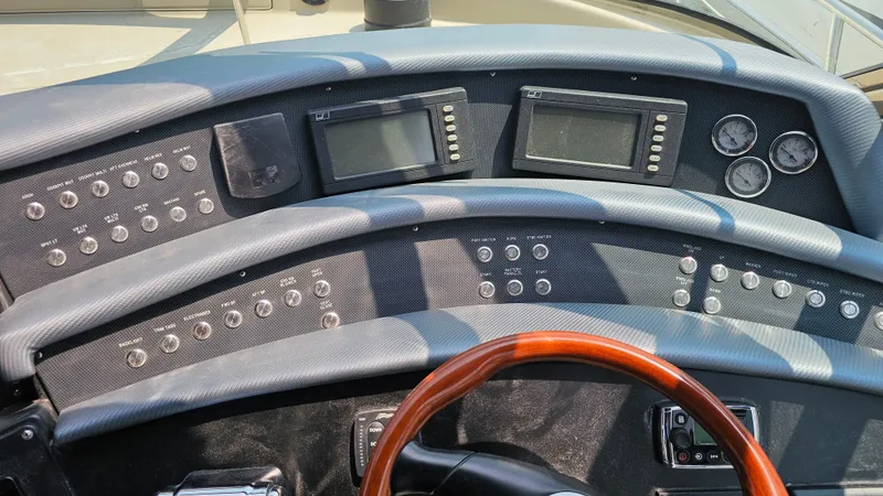 Slide: The Image of Dashboard of a 1999 Sea Ray 500 Sundancer yacht with controls and gauges. - 18